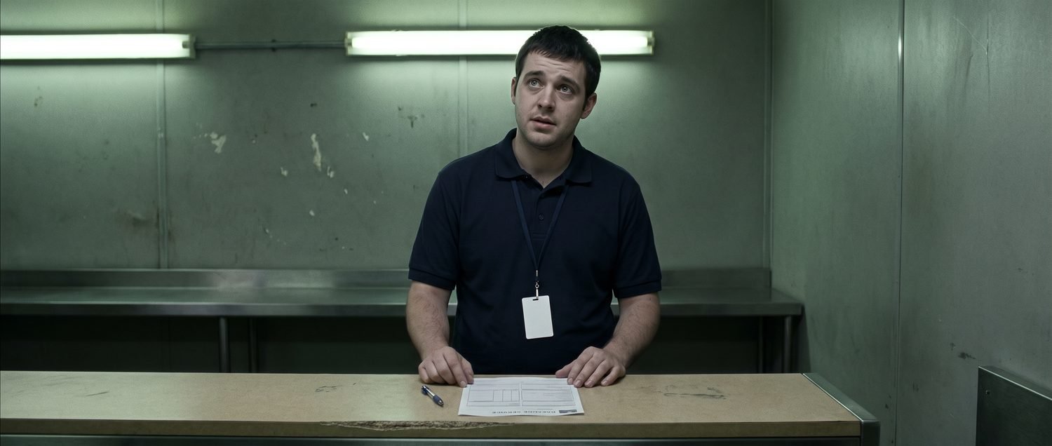 Alternate medium shot of Trevor behind the counter with the inventory form in front of him, from the version built without reference photographs.